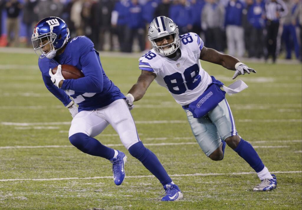 The New York Giants' Leon Hall (25) runs back an interception as Dallas Cowboys' Dez Bryant (88) chases him during the second half Sunday, Dec. 11, 2016, in East Rutherford, N.J. (AP Photo/Seth Wenig)