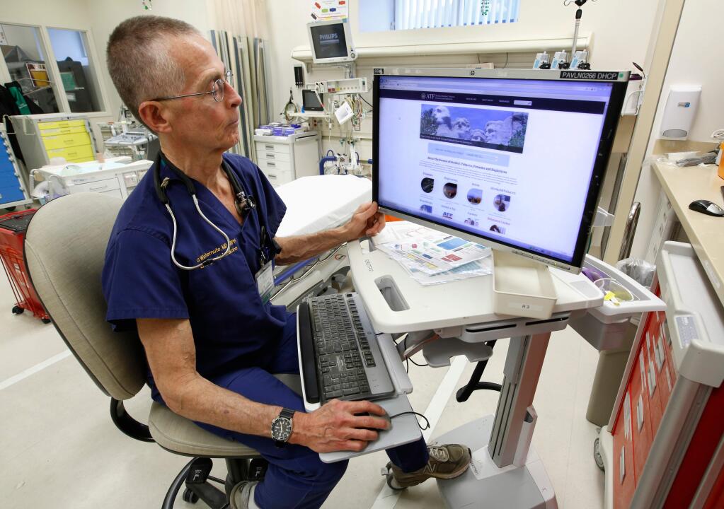 FILE - In this March 9, 2017 file photo, Dr. Garen Wintemute, an emergency room physician at the University of California, Davis, Medical Center, shows the website of the Bureau of Alcohol, Tobacco and Firearms, on a computer in the hospital in Sacramento, Calif. Gun deaths have fallen in California over a 16 year period ending in 2015, driven largely by a decline of African-American homicide victims, a recent and rare scientific study of firearm violence found. Researchers at the University of California, Davis published their findings in the May issue of Annals of Epidemiology after reviewing the 50,921 firearm deaths recorded in California between 2000 and 2015. The researchers said it's the first such deep analysis of California gun deaths in 30 years. (AP Photo/Rich Pedroncelli, File)