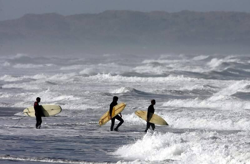 In this July 2020 photo, beginner surfers, left to right, Ben Perlman, Andrew Prokop and Dan Crowley from Petaluma brave the waters of Salmon Creek State Beach after a great white shark sighting in Marin closed the beaches there. (The Press Democrat, file)