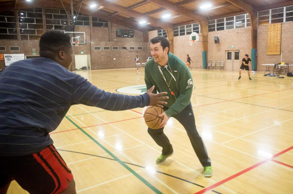 Coach Kevin Hardesty takes the ball to the hoop during practice at Rio Lindo Adventist Academy in Healdsburg, Calif. Monday, January 16, 2017. (Jeremy Portje / For The Press Democrat)
