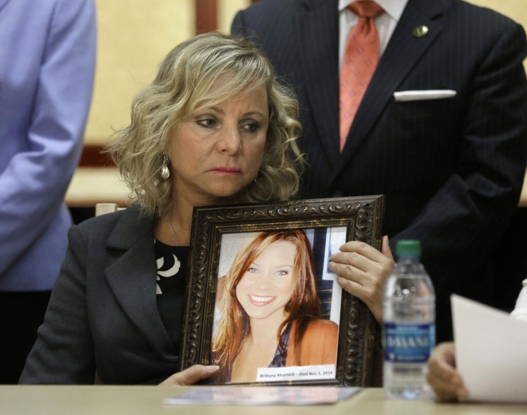 FILE - In a Tuesday, Aug. 18, 2015 file photo, Debbie Ziegler holds a photo of her daughter, Brittany Maynard, during a news conference to announce the reintroduction of right to die legislation, in Sacramento,Calif. The Simon & Schuster imprint Emily Bestler Books told The Associated Press on Tuesday, Sept. 8, 2015, that Deborah Zieglers memoir, Wild and Precious Life, was scheduled for late in 2016. (AP Photo/Rich Pedroncelli)