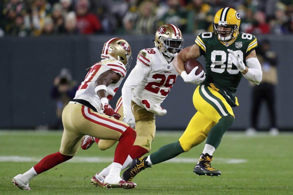 In this Monday, Oct. 15, 2018, file photo, Green Bay Packers tight end Jimmy Graham (80) runs against San Francisco 49ers free safety Adrian Colbert (27) and strong safety Jaquiski Tartt (29) after making a catch during the second half in Green Bay, Wis. (AP Photo/Matt Ludtke, File)