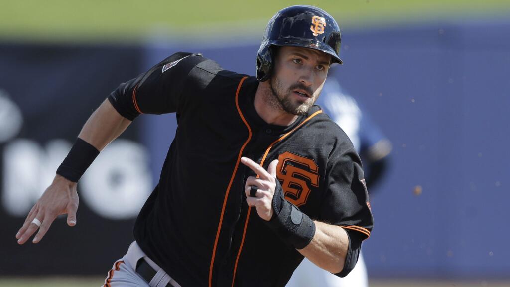 The San Francisco Giants' Steven Duggar heads to third from first on a single by Brandon Crawford during the third inning of a spring training game against the Milwaukee Brewers, Wednesday, Feb. 28, 2018, in Maryvale, Ariz. (AP Photo/Carlos Osorio)