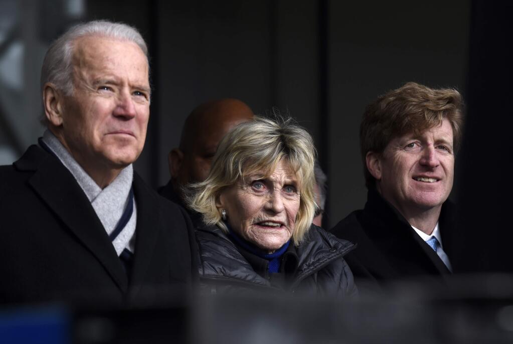 Jean Kennedy, center flanked by Vice President Joe Biden, left, and former Rhode Island Rep. Patrick Kennedy, listens during the dedication of the Edward M. Kennedy Institute for the United States Senate, Monday, March 30, 2015, in Boston. The $79 million Edward M. Kennedy Institute for the United States Senate dedication is a politically star-studded event attended by President Barack Obama, Vice President Joe Biden and past and present senators of both parties. It sits next to the presidential library of Kennedy's brother, John F. Kennedy. (AP Photo/Susan Walsh)