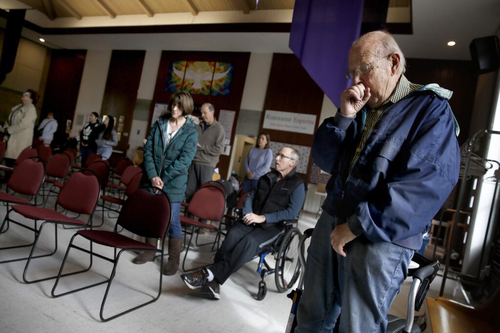 Warren Schneider, 83, covers his cough during a Sunday morning Mass at Holy Spirit Catholic Church in Santa Rosa on Sunday, March 15, 2020. (BETH SCHLANKER/ The Press Democrat)