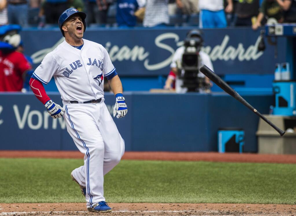 Toronto Blue Jays' Steve Pearce tosses his bat in celebration after hitting the game-winning walk off grand slam to defeat the Oakland Athletics 8-4 in the 10th inning of a baseball game in Toronto, Thursday July 27, 2017. (Mark Blinch/The Canadian Press via AP)
