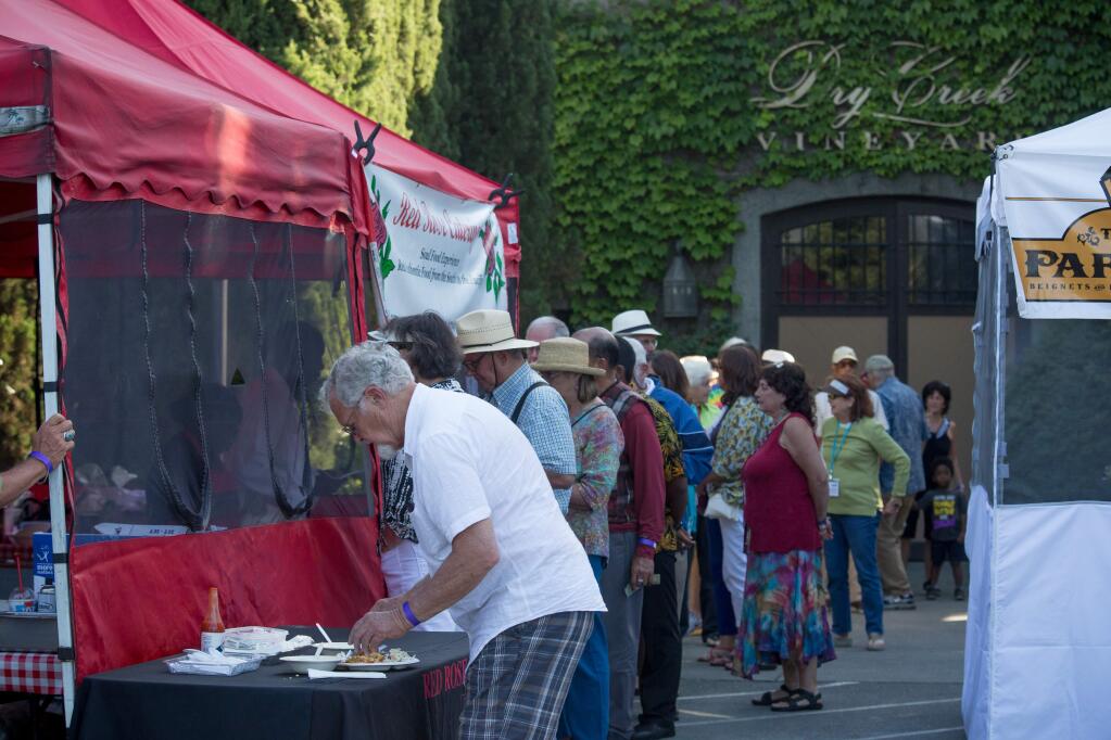 Guests line up for New Orleans themed food during the Healdsburg Jazz Festival's closing night festivities at Dry Creek Vineyard Sunday, June 12, 2016. Scores of music lovers took in the mild summer evening filled with New Orleans Jazz and food wrapping up 10 days of music at the festival.