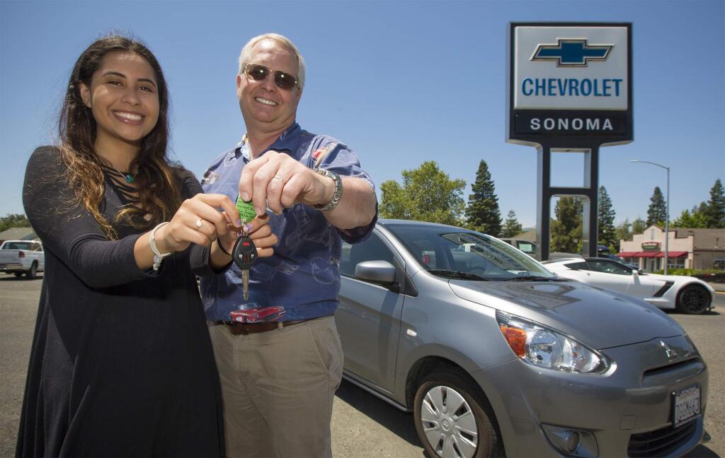 Sonoma Chevrolet's Dan Roseland presents the keys to a 2015 Mitsubishi Mirage to Sonoma High School graduate Roxana Belen Fonseca. The car was raffled off during Grad Night, the 9 p.m. to 5 a.m supervised party at the high school intended to offer graduates a safe celebration. (Photo by Robbi Pengelly/Index-Tribune)