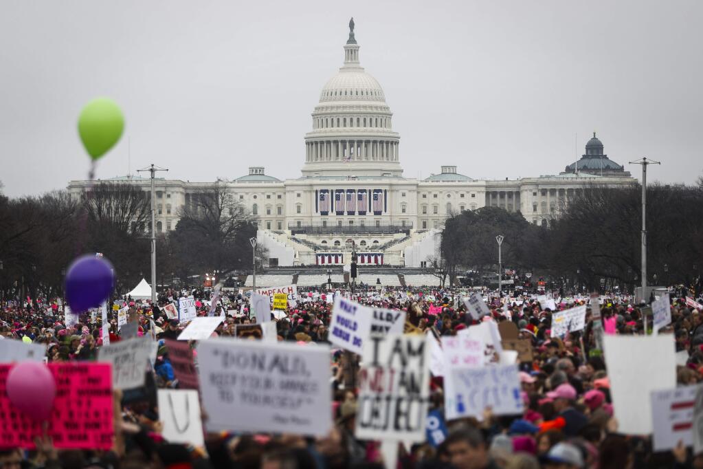 People gather Saturday on the National Mall for the Women's March on Washington. (JOHN MINCILLO / fAssociated Press)