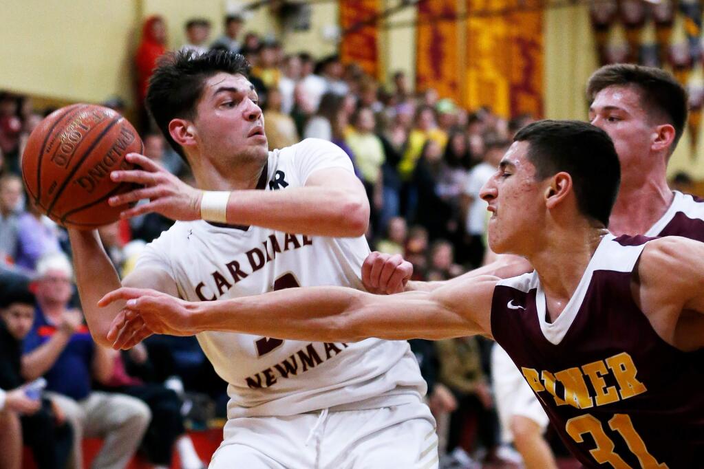Piner's Adrian Torres (31), right, tries to steal the ball from Cardinal Newman's Trevor Smith (33) during the first half of a boys varsity basketball game between Piner and Cardinal Newman high schools in Santa Rosa, California, on Friday, January 31, 2020. (Alvin Jornada / The Press Democrat)