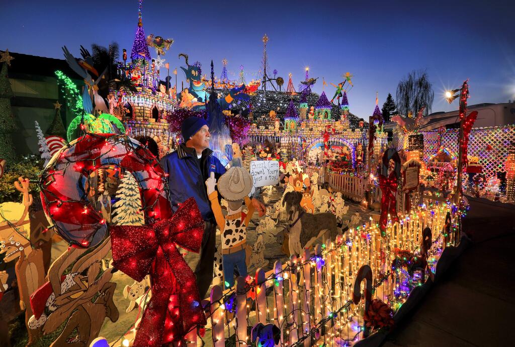 For 22 years Scott Weaver has spent weeks setting up handmade cartoon cutouts, castles and more than 35,000 Christmas lights at his home on Cielo Circle in Rohnert Park. Weaver turned on his display Thursday night, December 1st but says this year will be his last. (John Burgess/The Press Democrat)