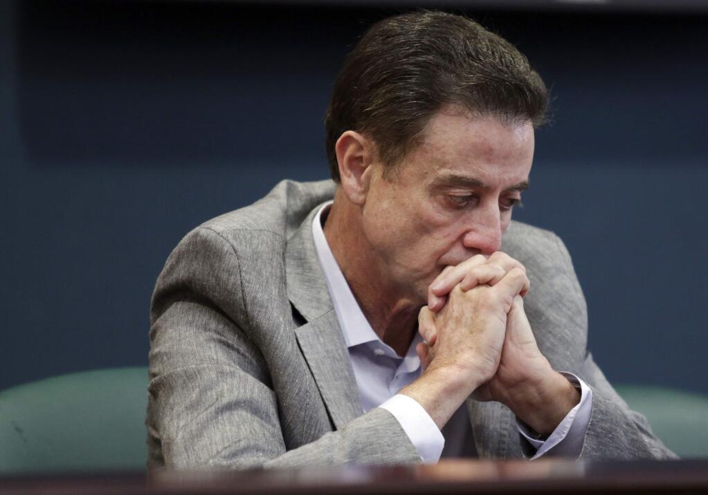 FILE - In this Thursday, June 15, 2017, file photo, Louisville basketball coach Rick Pitino listens during an NCAA college basketball news conference in Louisville, Ky. Louisville's Athletic Association has officially fired coach Rick Pitino, Monday, Oct. 16, 2017, nearly three weeks after the school acknowledged that its men's basketball program is being investigated as part of a federal corruption probe. (Alton Strupp/The Courier-Journal via AP, File)