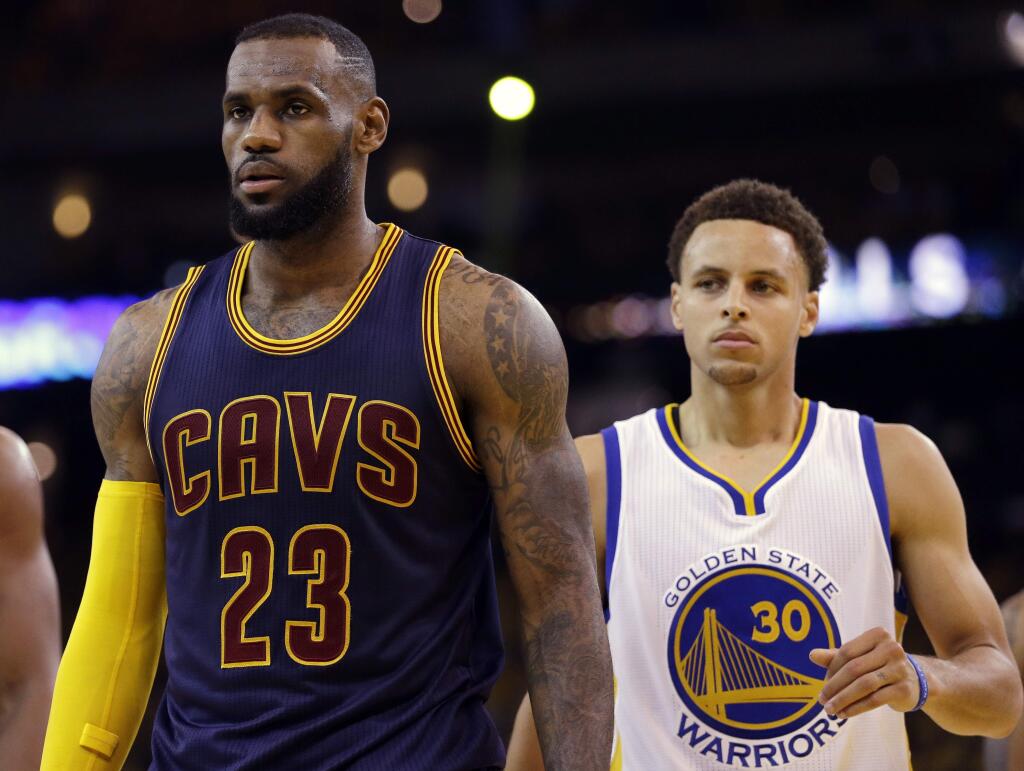 Cleveland Cavaliers forward LeBron James (23) walks in front of Golden State Warriors guard Stephen Curry (30) during the first half of Game 5 of basketball's NBA Finals in Oakland, Calif., Sunday, June 14, 2015. (AP Photo/Ben Margot)