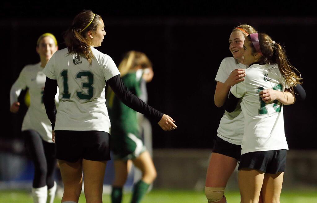 Sonoma Academy's Quoya Mann (9), second from right, is congratulated by teammates Sage Stack (13), left, and Sophie Vargas (18) after scoring the Coyotes' second goal of the game during the first half of the NCS tournament first round girls varsity soccer match between Head-Royce and Sonoma Academy in Santa Rosa, California, on Wednesday, February 14, 2018. (Alvin Jornada / The Press Democrat)