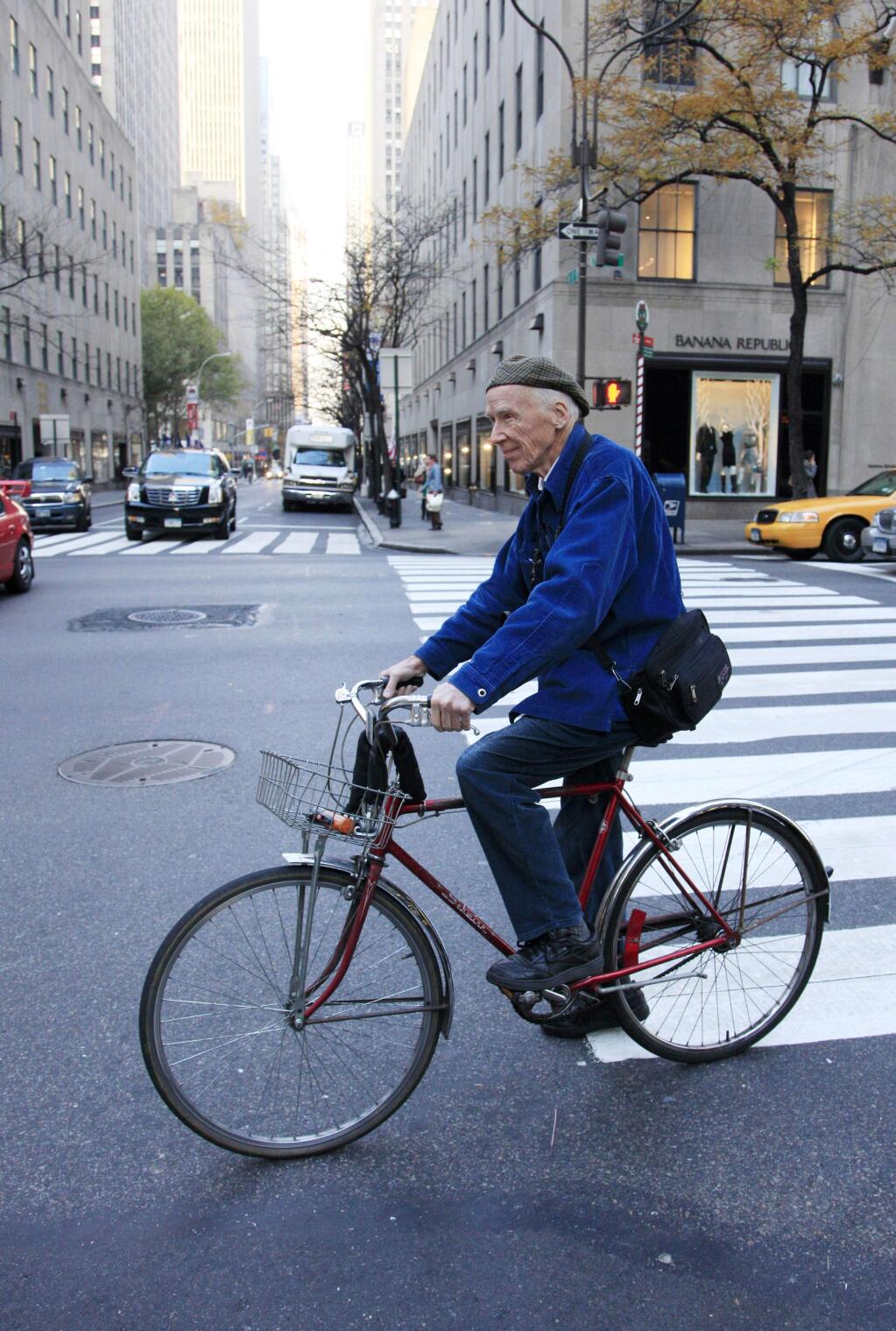 FILE - In this Nov. 23, 2010 file photo, New York Times photographer Bill Cunningham bicycles to work in New York. Cunningham, a longtime fashion photographer for The New York Times known for taking pictures of everyday people on the streets in New York died on Saturday, June 25, 2016, after suffering a stroke in New York. He was 87. (AP Photo/Mark Lennihan, File)