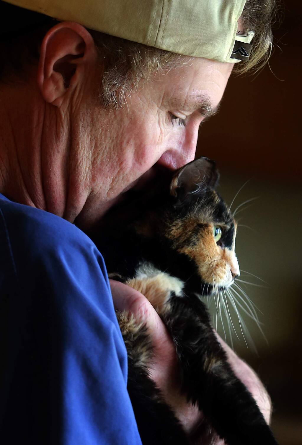 PHOTO: 2 by JOHN BURGESS / The Press Democrat -Darryl Roberts snuggles with Pumpkin, who is afflicted with cerebellar hypoplasia and has difficulties walking. Roberts founded SNAP Cats for abused, injured and disabled cats out of his Dry Creek apartment.