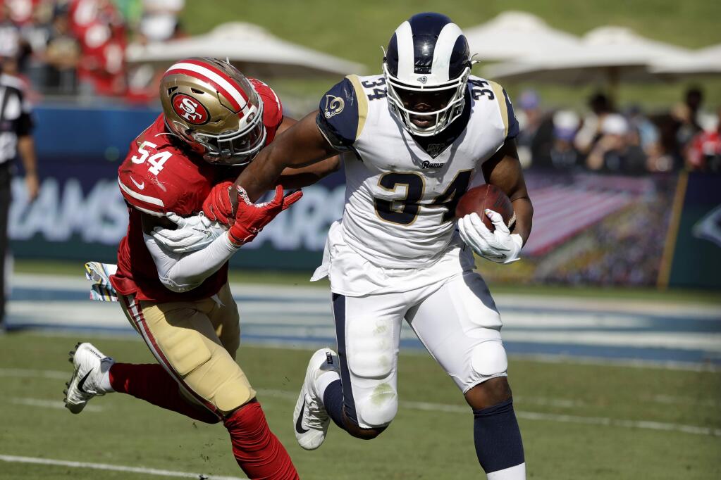 San Francisco 49ers middle linebacker Fred Warner (54) stops Los Angeles Rams running back Malcolm Brown (34) during the second half of an NFL football game Sunday, Oct. 13, 2019, in Los Angeles. (AP Photo/Alex Gallardo )