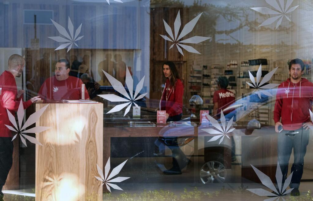FILE - In this Dec. 21, 2017 file photo, bud tenders wait for customers at MedMen, a medical marijuana dispensary in Los Angeles. Attorney General Jeff Sessions has rescinded an Obama-era policy that paved the way for legalized marijuana to flourish in states across the country, creating new confusion about enforcement and use just three days after a new legalization law went into effect in California. (AP Photo/Richard Vogel, File)