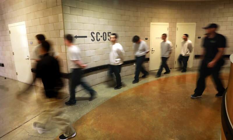 Juvenile Hall guards walk inmates from their unit to a meeting at the facility at the base of Hood Mountain in this May file photo. (John Burgess/The Press Democrat.