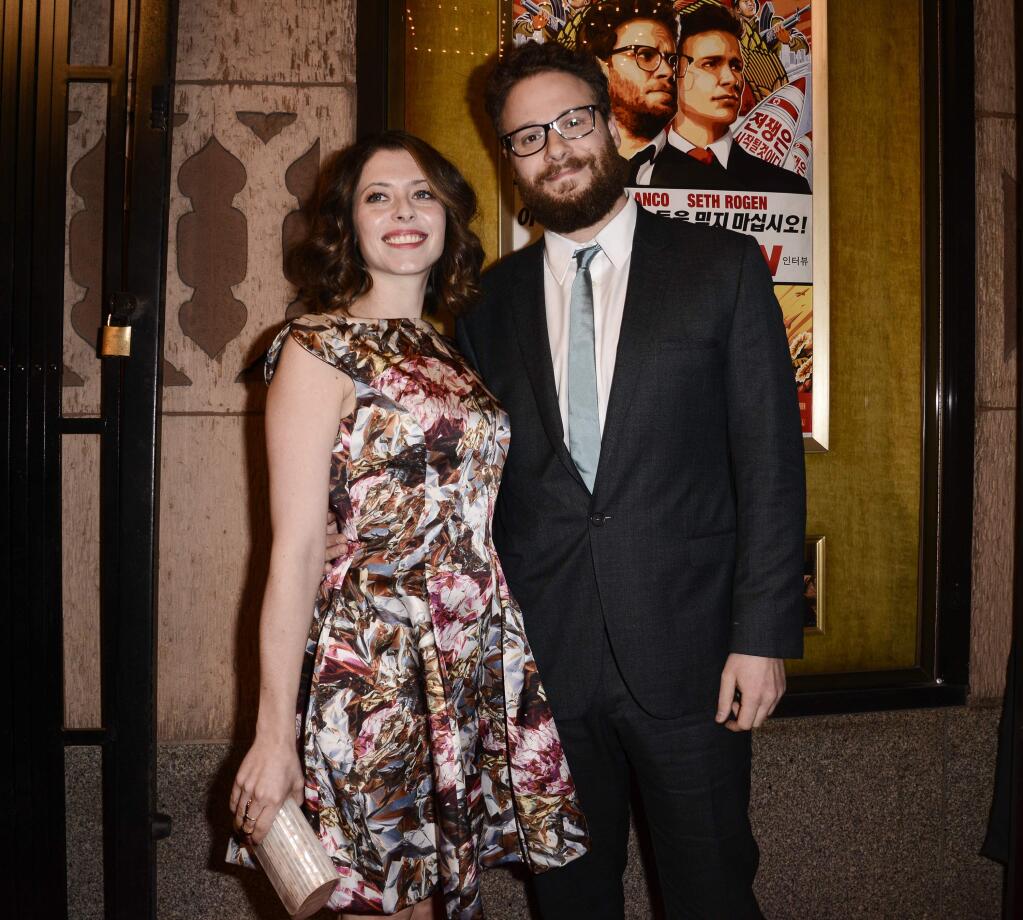 Actor Seth Rogen, right, and his wife Lauren Miller attend the premiere of the feature film 'The Interview' in Los Angeles on Thursday, Dec. 11, 2014. (Photo by Dan Steinberg/Invision/AP Images)