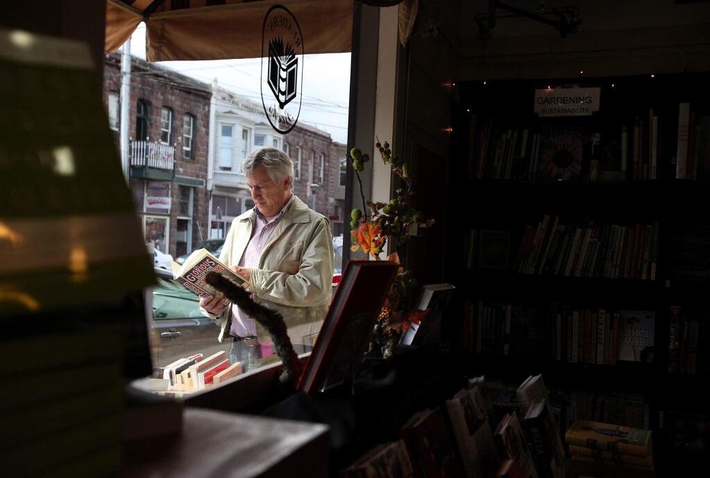 Kevin Seely looks at a book on an outdoor shelf at Readers' Books in Sonoma . File photo.