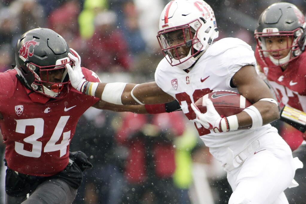 Stanford running back Bryce Love, right, stiff arms Washington State safety Jalen Thompson (34) while running for a touchdown during the first half of an NCAA college football game in Pullman, Wash., Saturday, Nov. 4, 2017. (AP Photo/Young Kwak)