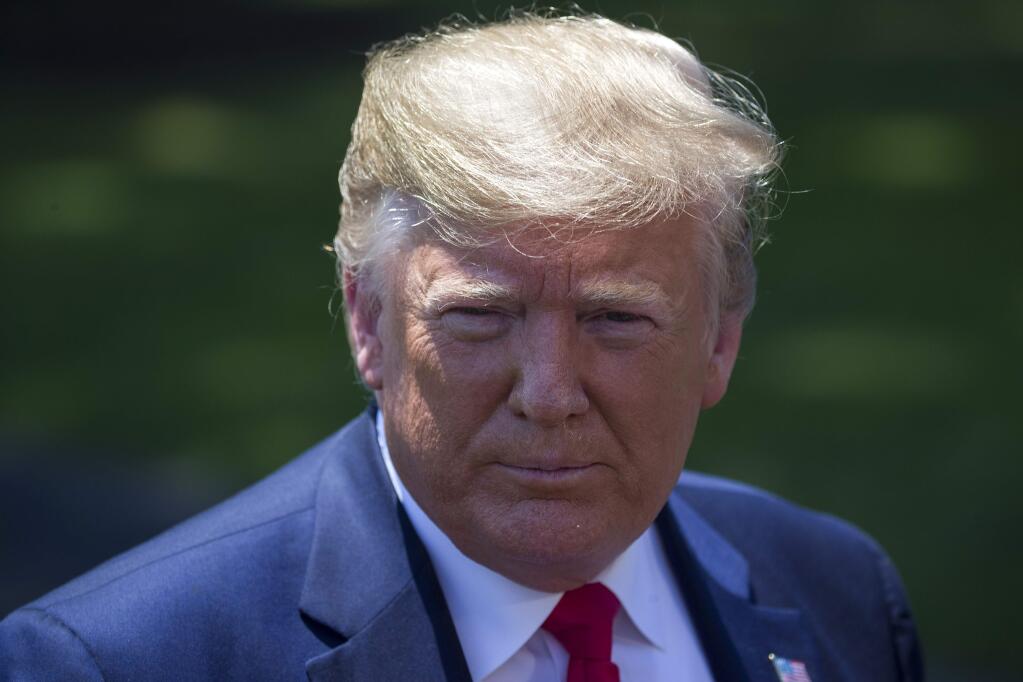President Donald Trump listens to a question as he speaks with reporters on the South Lawn of the White House, Wednesday, June 26, 2019, in Washington. Trump is en route to Japan for the G-20 summit. (AP Photo/Alex Brandon)