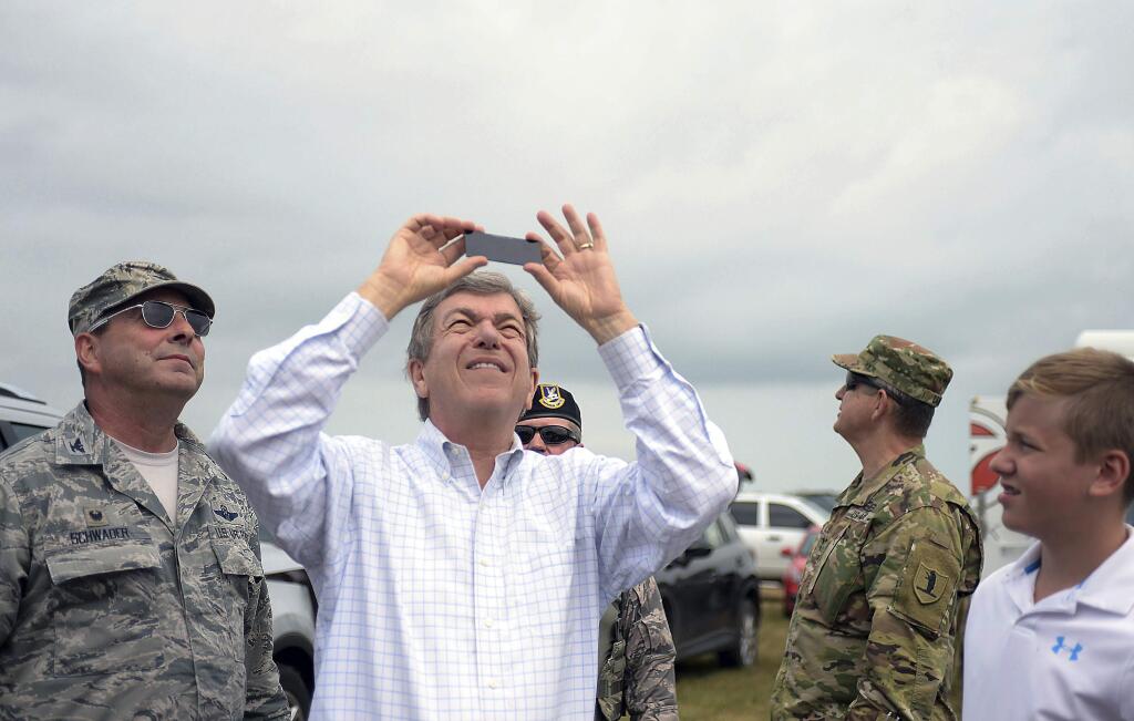 Sen. Roy Blunt views the beginning of the total solar eclipse at Rosecrans Memorial Airport on Monday, Aug. 21, 2017, in St. Joseph, Mo. (Jessica A. Stewart/The St. Joseph News-Press via AP)