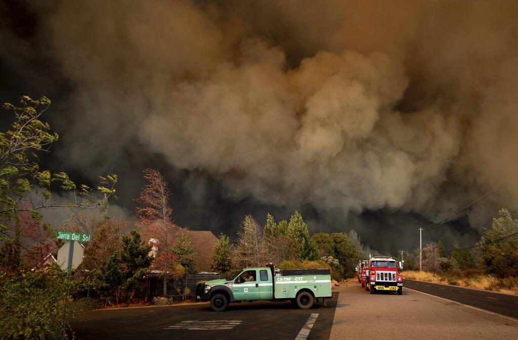 The Camp Fire rages through Paradise, Calif., on Thursday, Nov. 8, 2018. Tens of thousands of people fled a fast-moving wildfire Thursday in Northern California, some clutching babies and pets as they abandoned vehicles and struck out on foot ahead of the flames that forced the evacuation of an entire town. (AP Photo/Noah Berger)