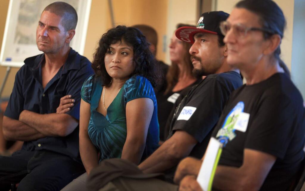 Kent porter / The Press DemocratHomeless Hill residents Thyda Pok, middle left and Joseph Converse, middle right, listen closely to questions submitted by the audience about their encampments during a community info meeting Monday at Congregation Shomrei Torah in Santa Rosa.