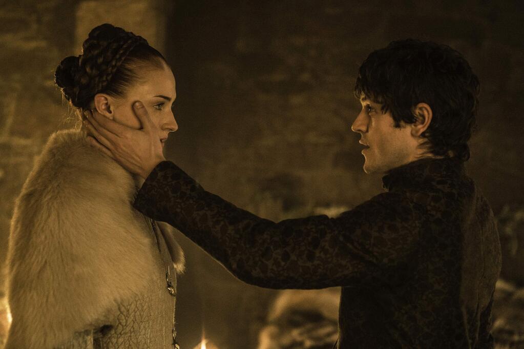 This photo provided by courtesy of HBO shows, Sophie Turner, left, as Sansa Stark, and Iwan Rheon, as Ramsay Bolton, in a scene from season 5 of 'Game of Thrones.' The show airs Sundays at 9 p.m. EDT. (Helen Sloan/HBO via AP)