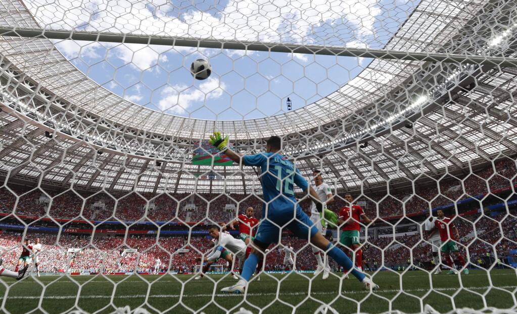Portugal's Cristiano Ronaldo scores his side's opening goal during the group B match between Portugal and Morocco at the 2018 soccer World Cup in the Luzhniki Stadium in Moscow, Russia, Wednesday, June 20, 2018. (AP Photo/Matthias Schrader)