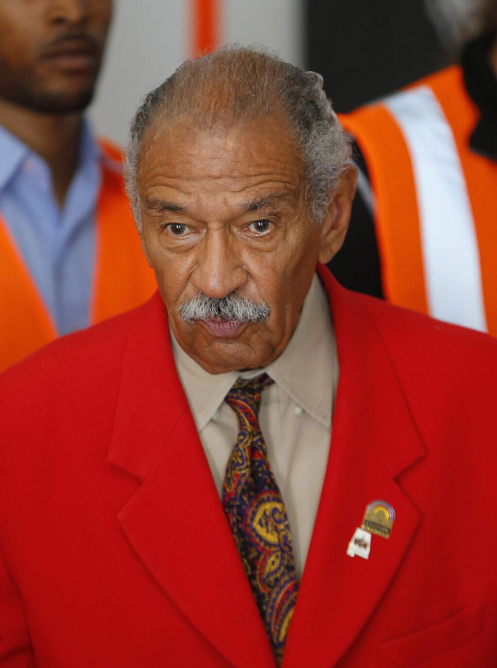 FILE - In this July 7, 2014 file photo, U.S. Rep. John Conyers, D-Mich., speaks in Detroit. The longtime Michigan Congressman on Tuesday, Nov. 21, 2017, denied settling a sexual harassment complaint in 2015 from a woman who alleged she was fired from his Washington staff because she rejected his sexual advances. (AP Photo/Paul Sancya)