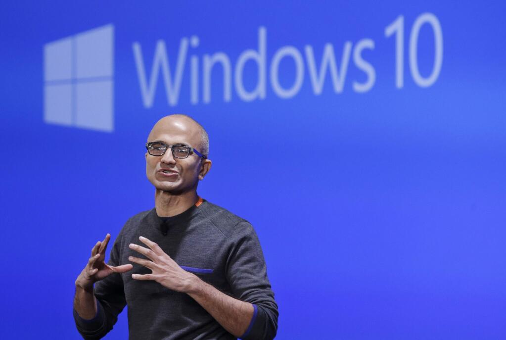 Microsoft CEO Satya Nadella speaks at an event demonstrating the new features of Windows 10 at the company's headquarters Wednesday, Jan. 21, 2015, in Redmond, Wash. Executives demonstrated how they said the new Windows is designed to provide a more consistent experience and a common platform for software apps on different devices, from personal computers to tablets, smartphones and even the company's Xbox gaming console. (AP Photo/Elaine Thompson)