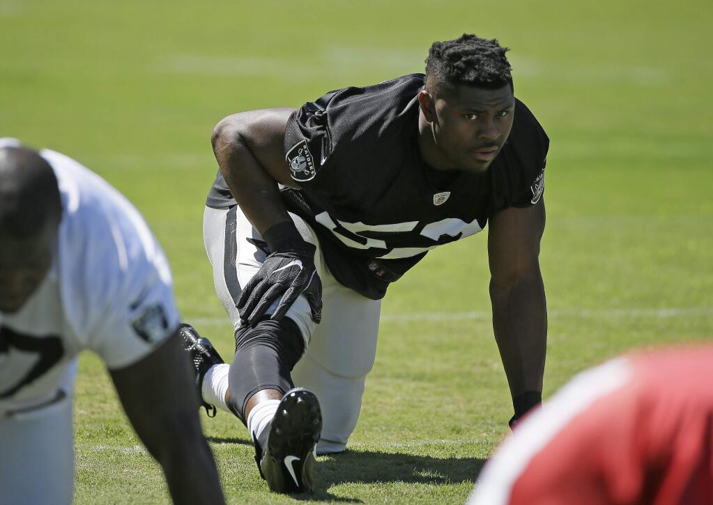 Oakland Raiders defensive end Khalil Mack stretches during practice at the team's training camp Friday, July 29, 2016, in Napa. (AP Photo/Eric Risberg)