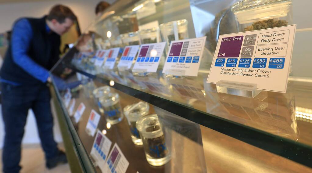 Jesse Knapp of Santa Rosa left, looks to purchase products at SPARC Cannabis Clinic in Santa Rosa on Monday Jan. 22, 2018, (KENT PORTER/ PD FILE)