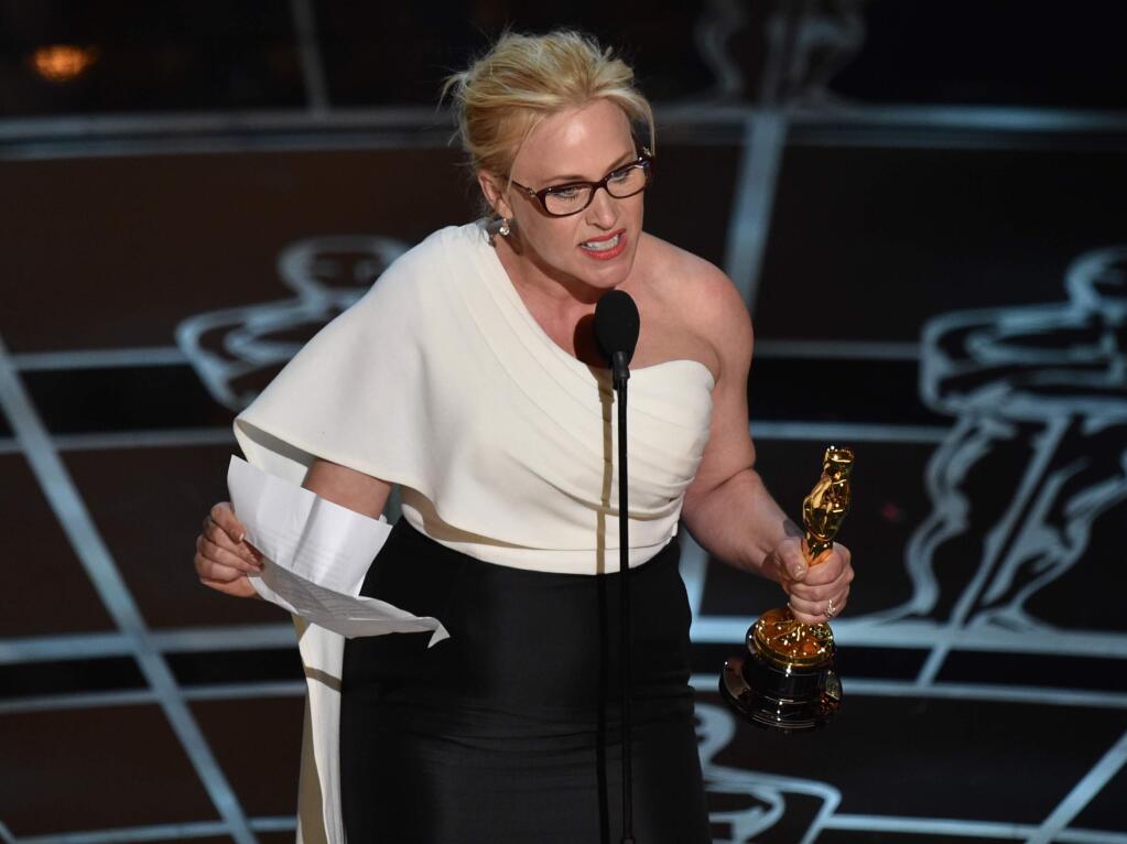 Patricia Arquette accepts the award for best actress in a supporting role for Boyhood at the Oscars on Sunday, Feb. 22, 2015, at the Dolby Theatre in Los Angeles. (Photo by John Shearer/Invision/AP)