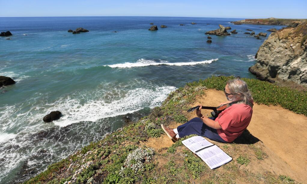 Bill Blodgett of Calistoga takes time to strum a tune on the Sonoma Coast north of Bodega bay, Friday April 10, 2015. (Kent Porter / Press Democrat) 2015