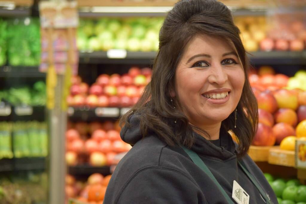 Marina DeDominguez, assistant manager in produce for the Stony Point Oliver's Market store in Santa Rosa, seeks to understand what the new employee stock owner plan (ESOP) means. (James Dunn / North Bay Business Journal) March 2018