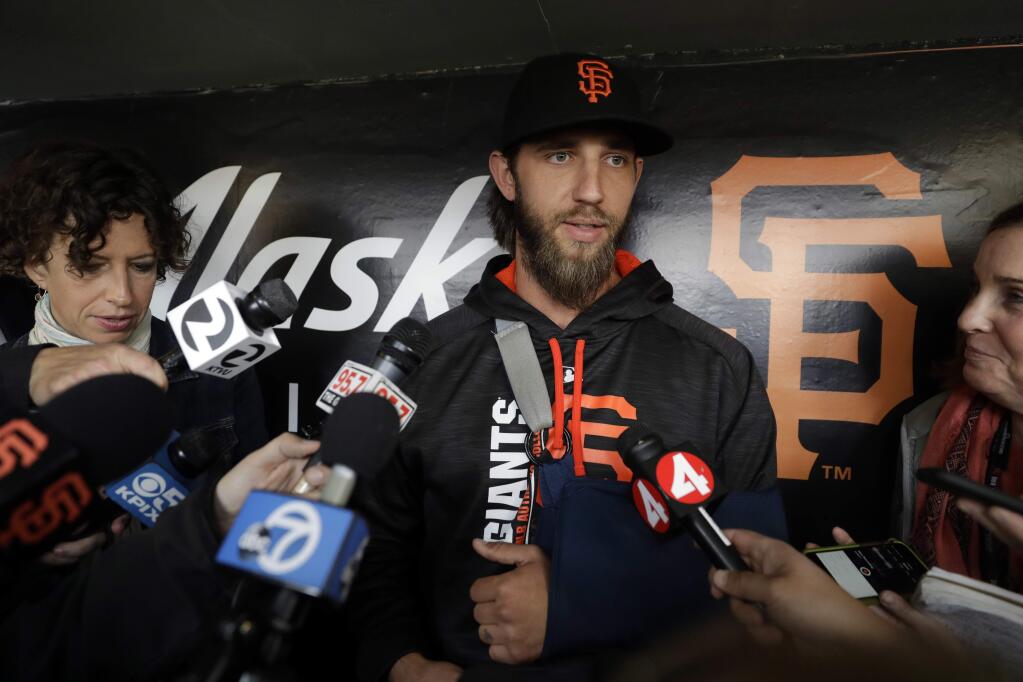 San Francisco Giants pitcher Madison Bumgarner answers questions about his shoulder injury before a baseball game against the Los Angeles Dodgers, Monday, April 24, 2017, in San Francisco . (AP Photo/Marcio Jose Sanchez)