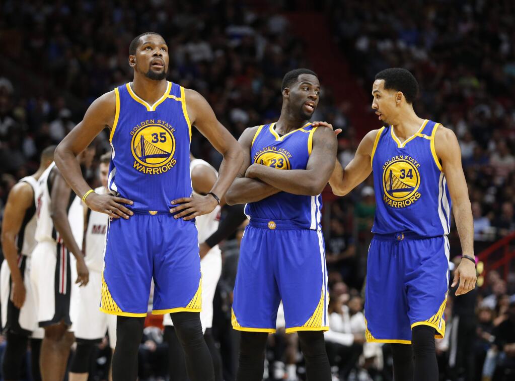 Golden State Warriors forwards Kevin Durant and Draymond Green and guard Shaun Livingston during the second half against the Miami Heat, Monday, Jan. 23, 2017, in Miami. The Heat defeated the Warriors 105-102. (AP Photo/Wilfredo Lee)