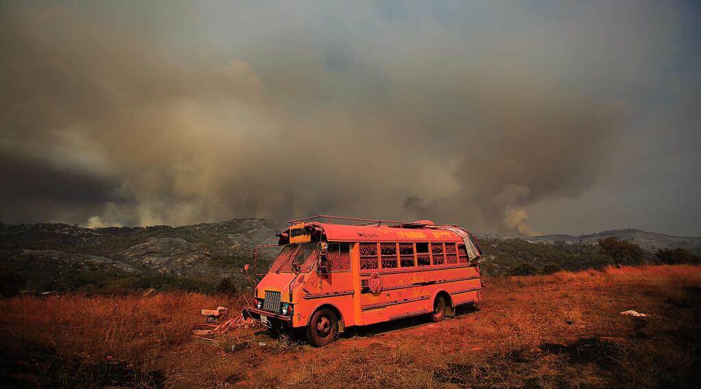 A bus fell victim to the Rocky fire in Lake County, Thursday, July 30, 2015. Gov. Jerry Brown has declared a state of emergency in the California Wildfires. (Kent Porter / Press Democrat)