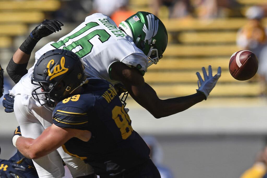 In this Sept. 14, 2019, file photo, Cal's Evan Weaver (89) tackles North Texas' Jyaire Shorter (16) while attempting to catch a pass on fourth down in the fourth quarter in Berkeley. (Jose Carlos Fajardo/San Jose Mercury News via AP, File)