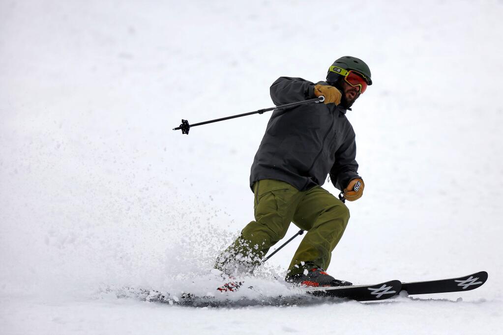FILE – A skier makes a turn at Squaw Valley Resort in Olympic Valley, California on Wednesday, December 9, 2015. (Alvin Jornada / The Press Democrat)