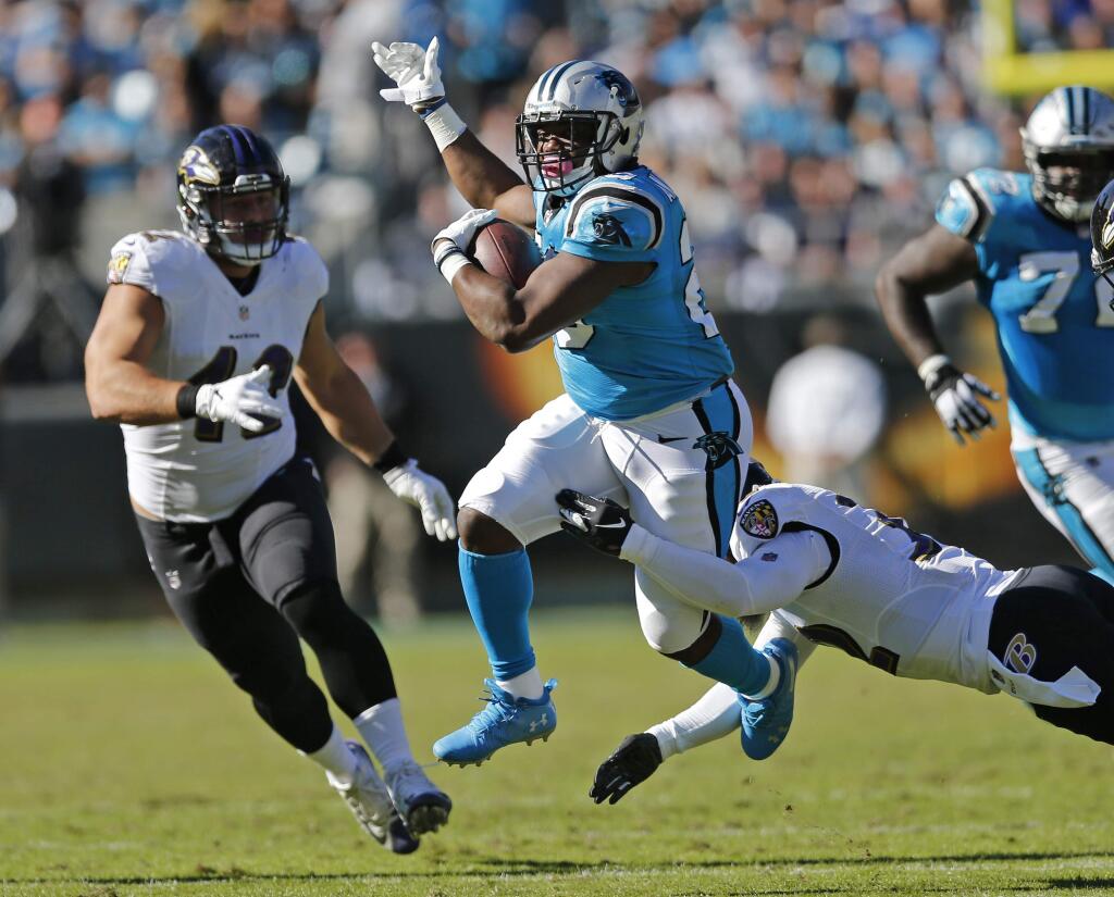 The Carolina Panthers' C.J. Anderson (20) runs as the Baltimore Ravens' Patrick Ricard (42) closes in the second half in Charlotte, N.C., Sunday, Oct. 28, 2018. (AP Photo/Nell Redmond)