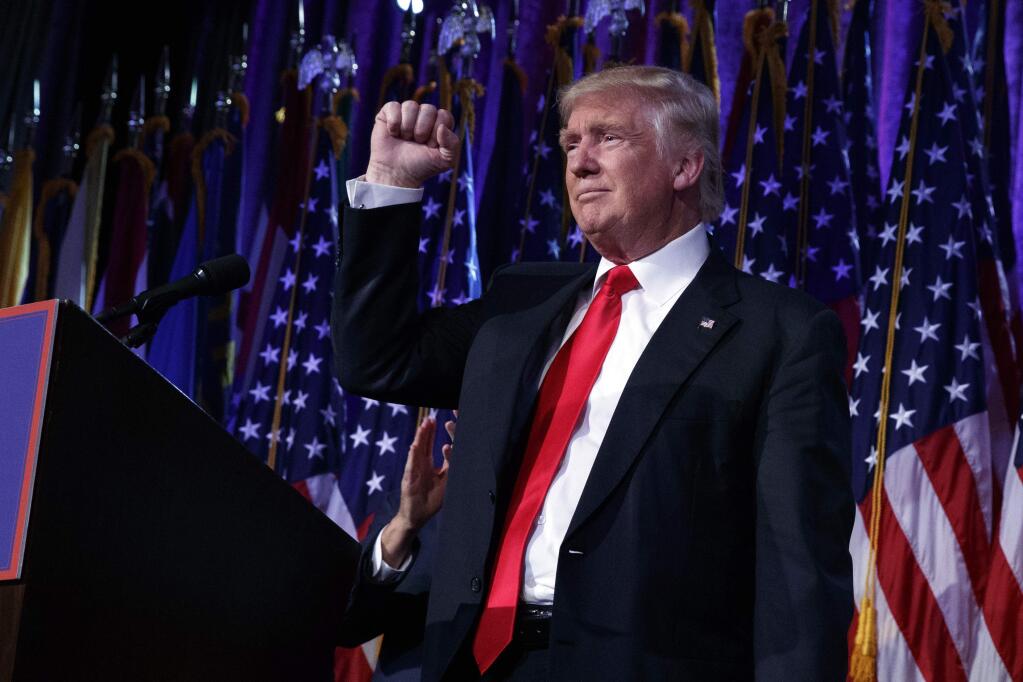 President-elect Donald Trump pumps his fist during an election night rally, Wednesday, Nov. 9, 2016, in New York. (AP Photo/ Evan Vucci)