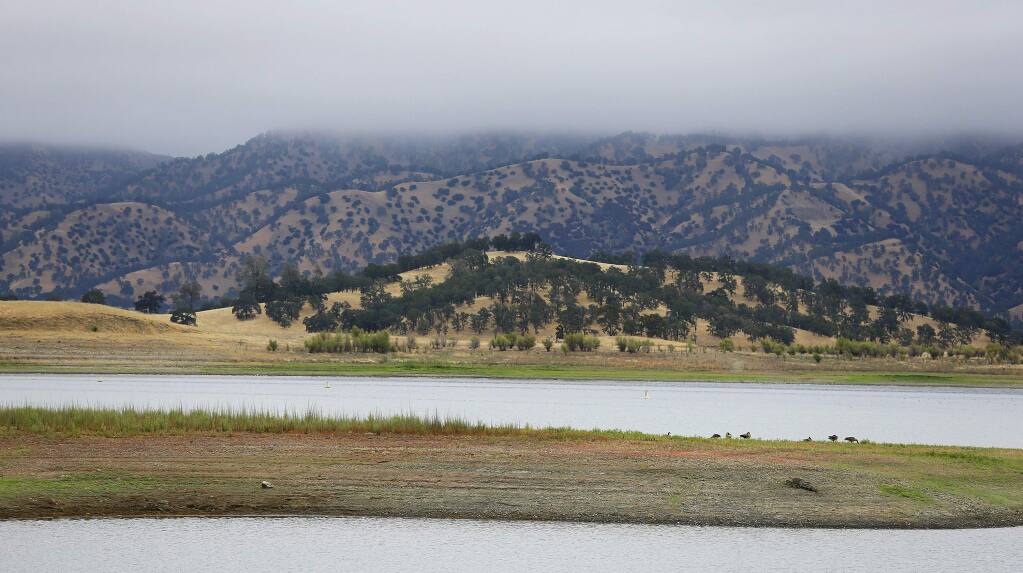 Lake Berryessa is seen with parts of California's newest national monument in the background, Friday, July 10, 2015, near Berryessa Snow Mountain National Monument, Calif. California's newest national monument covers hundreds of thousands of acres from marshes to the mountain peaks 6,000 feet above them. Federal protection will let an entire coastal range better weather the warming of climate change, supporters say. (AP Photo/Eric Risberg)