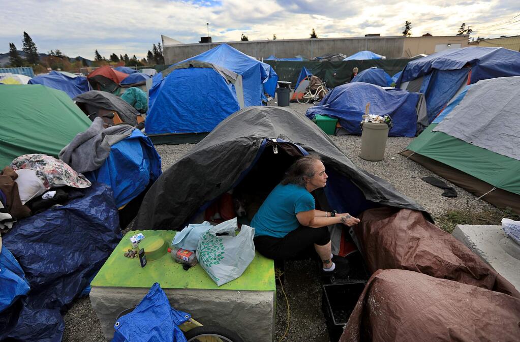 Ellen Brown pitched her tent adjacent to Camp Michela, or Remembrance Village, Friday Nov. 24, 2017 behind the Dollar Tree store in Roseland. Since the purge of homeless from Santa Rosa's downtown over crossings, the Roseland spot has burgeoned with new arrivals to the camp. (Kent Porter / Press Democrat) 2017