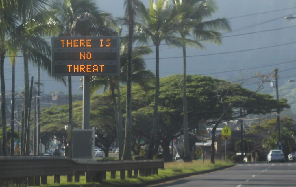 This Saturday, Jan. 13, 2018, photo provided by Jhune Liwanag shows a highway median sign broadcasting a message of 'There is no threat' in Kaneohe, Hawaii. State emergency officials mistakenly sent out an emergency alert warning of an imminent missile strike, sending islanders into a panic. (Jhune Liwanag via The AP)
