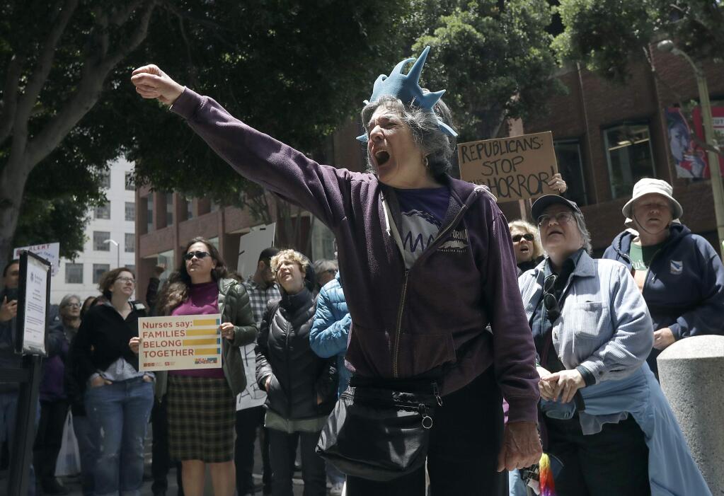 Protester Ann Marie Stenberg yells outside of the Immigration and Customs Enforcement (ICE) office in San Francisco, Tuesday, June 19, 2018. (AP Photo/Jeff Chiu)